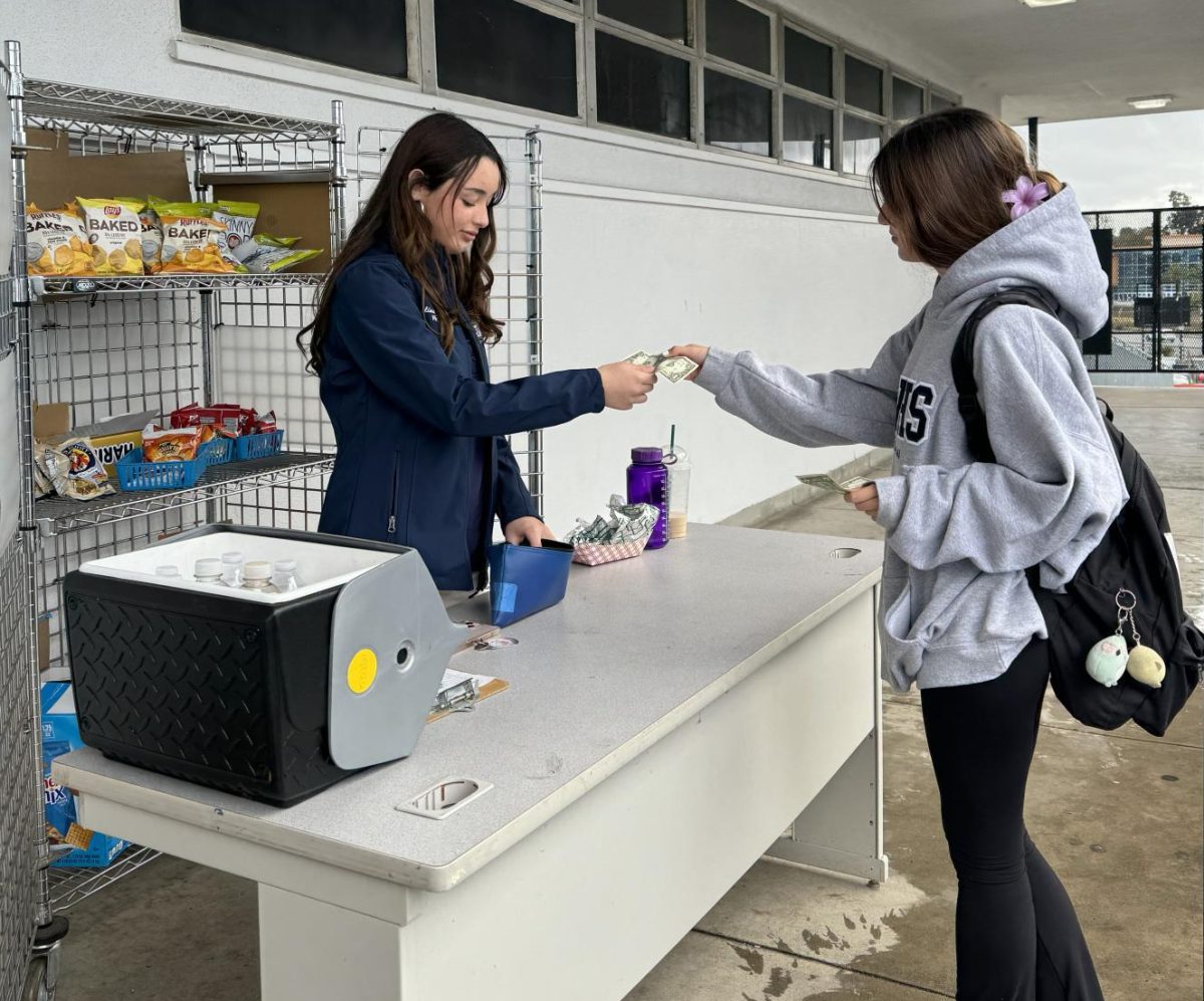 On Feb. 2, Bonita Vista High (BVH) students line up to buy food from the Associated Student Body (ASB) during lunch. BVH ASB Finance Commissioner and junior Paulina Gutierrez collects the money from BVH junior Joann Hahn before buying one of the many snacks offered.