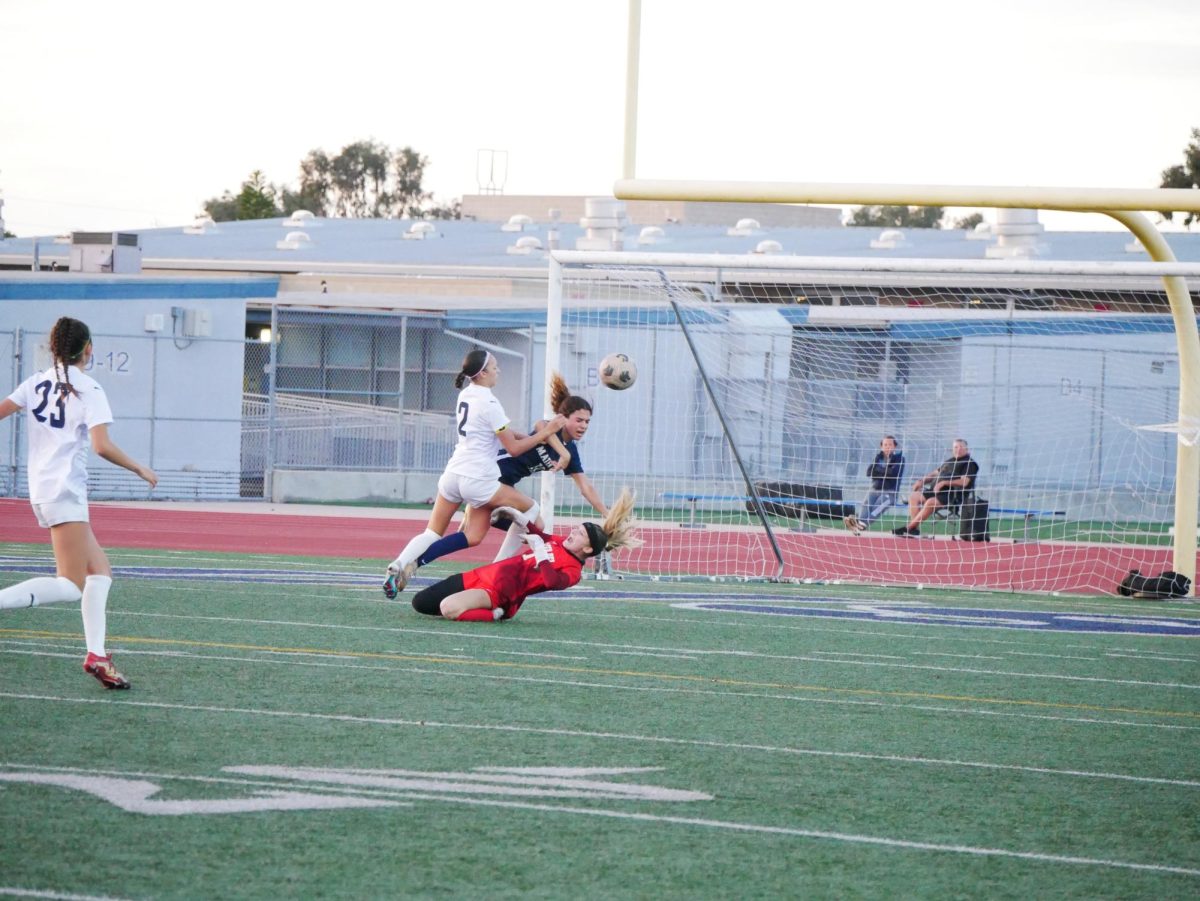 The Bonita Vista High (BVH) girls varsity soccer team faced Mater Dei Catholic (MDC) in the Division I CIF championship at Madison High School. Midway through the game, a chaotic clash of players occurs near MDCs goal. 
