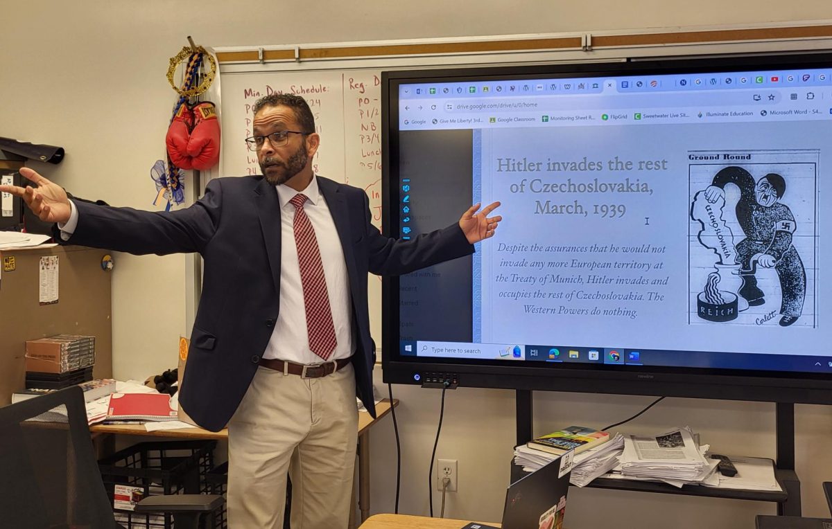 United States (U.S.) History and Advanced Placement (AP) African American studies teacher Don Dumas teaching a relative topic of war and conflict between Hitler invading Czechoslovakia during World War II.
