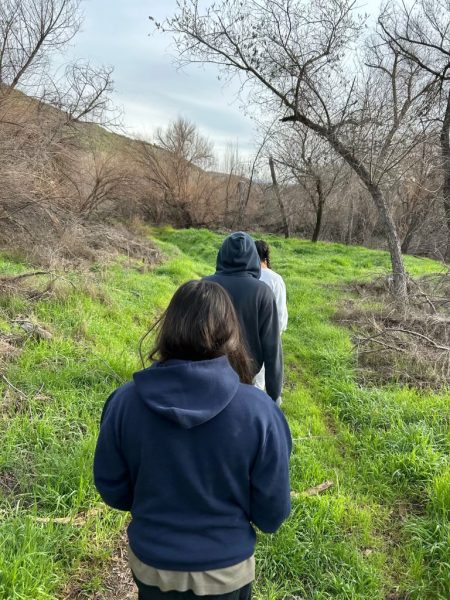 On Feb. 25, BVH senior Aparri Tarpley, senior Poppy Constantino and senior Sarah Hardin walk along a trail located behind the Temecula KOA campground. This trail leads to the flooded lake they later discovered.