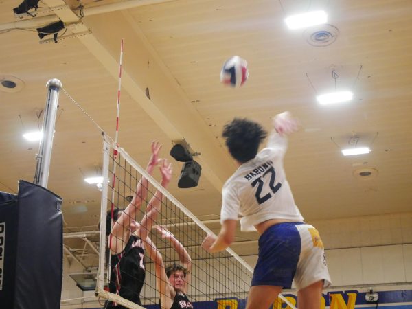 On Feb. 21, the Bonita Vista High (BVH) Barons faced the Santa Fe Christian (SFC) Eagles in a 2-1 home victory. BVH co-Captain, outside hitter and senior Daniel Robitaille (22) loads his shot against his opponents.  