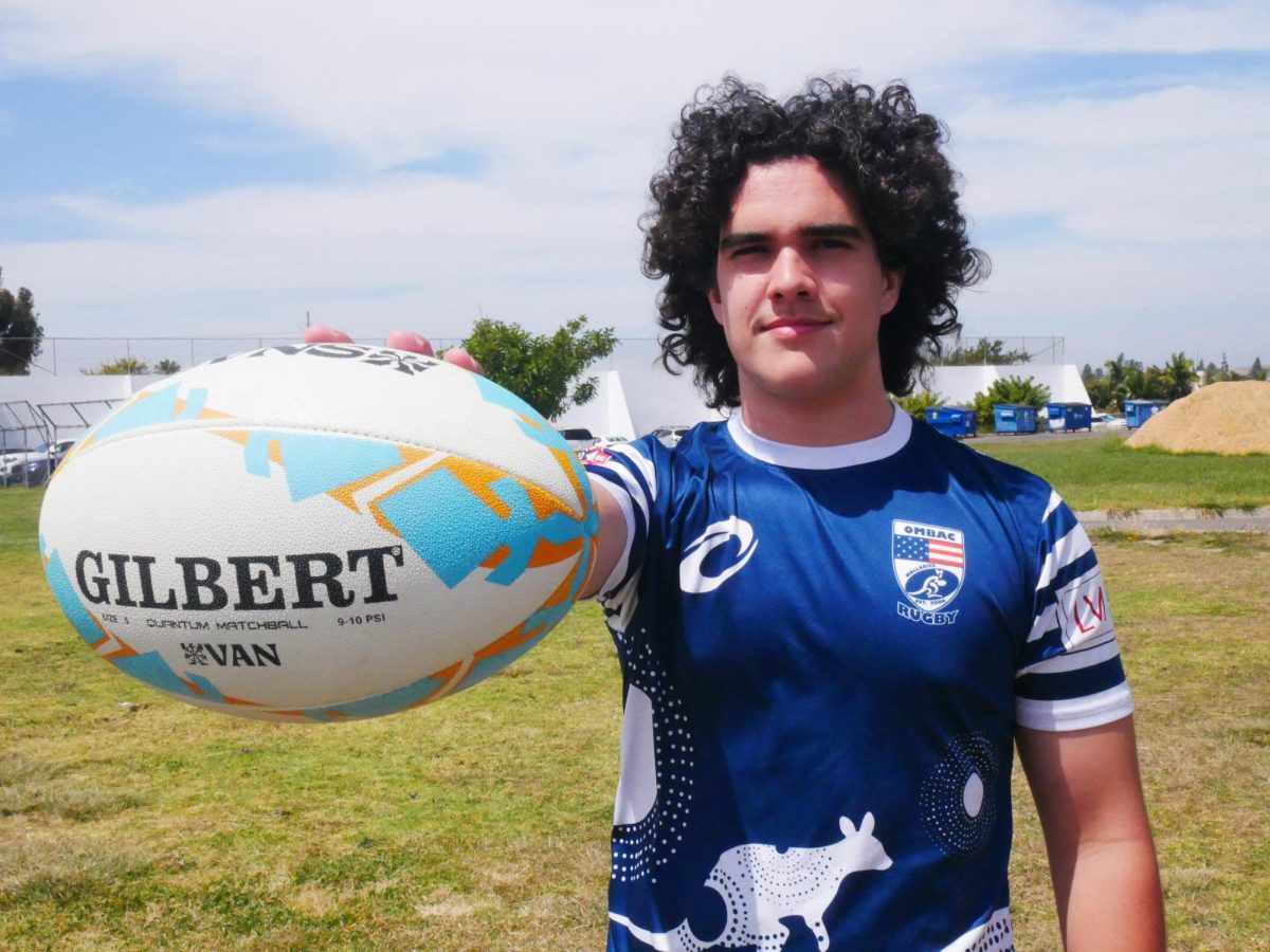BVH football player and junior Guillermo Smith poses with his rugby ball while
sporting his club jersey. Smith’s passion for rugby has fueled his commitment
to the generally unpopular sport.