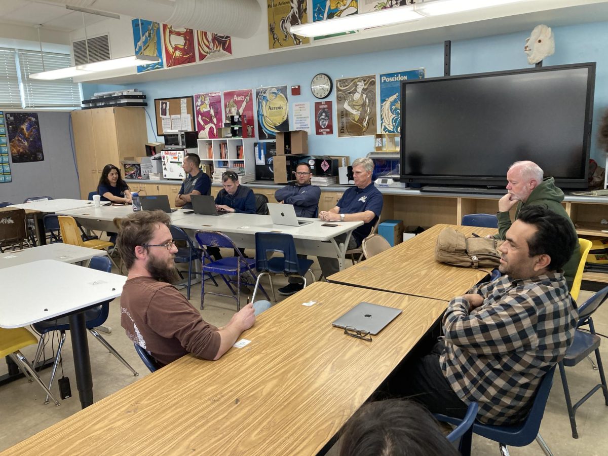 International Baccalaureate Higher Level 1 teacher Jason Good discusses with Advanced Placement Literature teacher Juan Garcia. Throughout their meeting, they discuss their plan on revising their plans for next year. 
