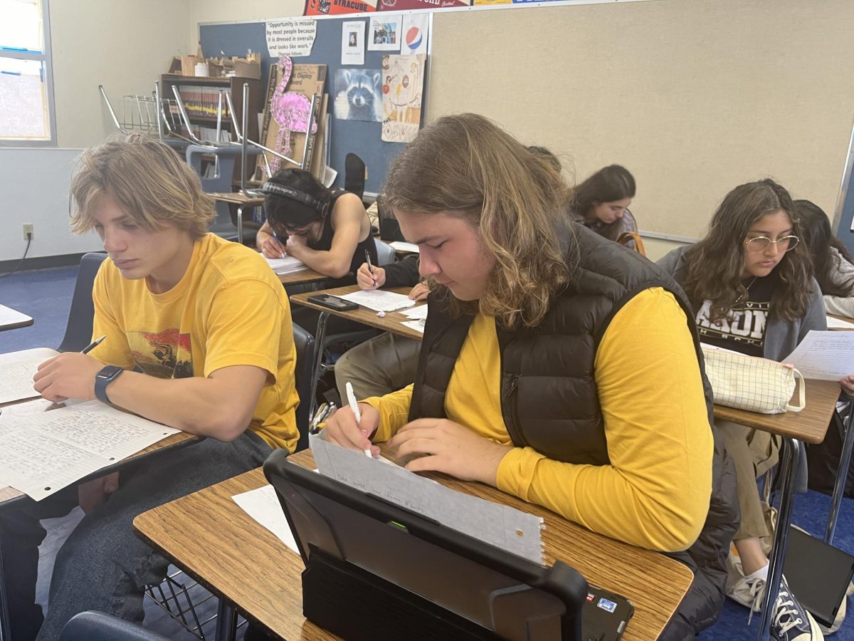 On April 25, during fifth period, sophomores Conlan Murphy and Jeremy Berke practice writing a synthesis essay prepping for the Advanced Placement (AP) English Language exam. The AP English Language exam is one of the many AP exams that will be taken on paper this year.