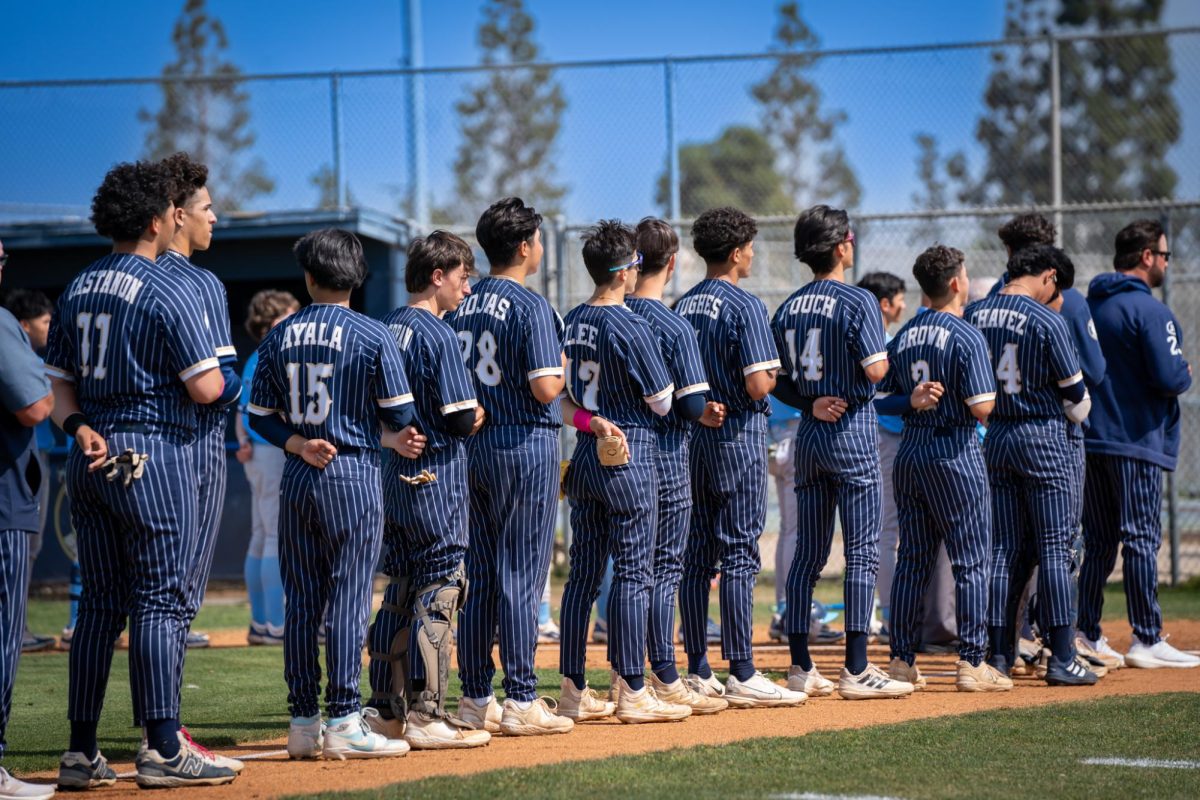 On May. 2, the Bonita Vista High (BVH) Barons boys varsity baseball team took on the Otay Ranch High (ORH) Mustangs in a twelve inning slug fest, ending in a 3-2 victory. The BVH team removes their caps for the pledge of allegiance.