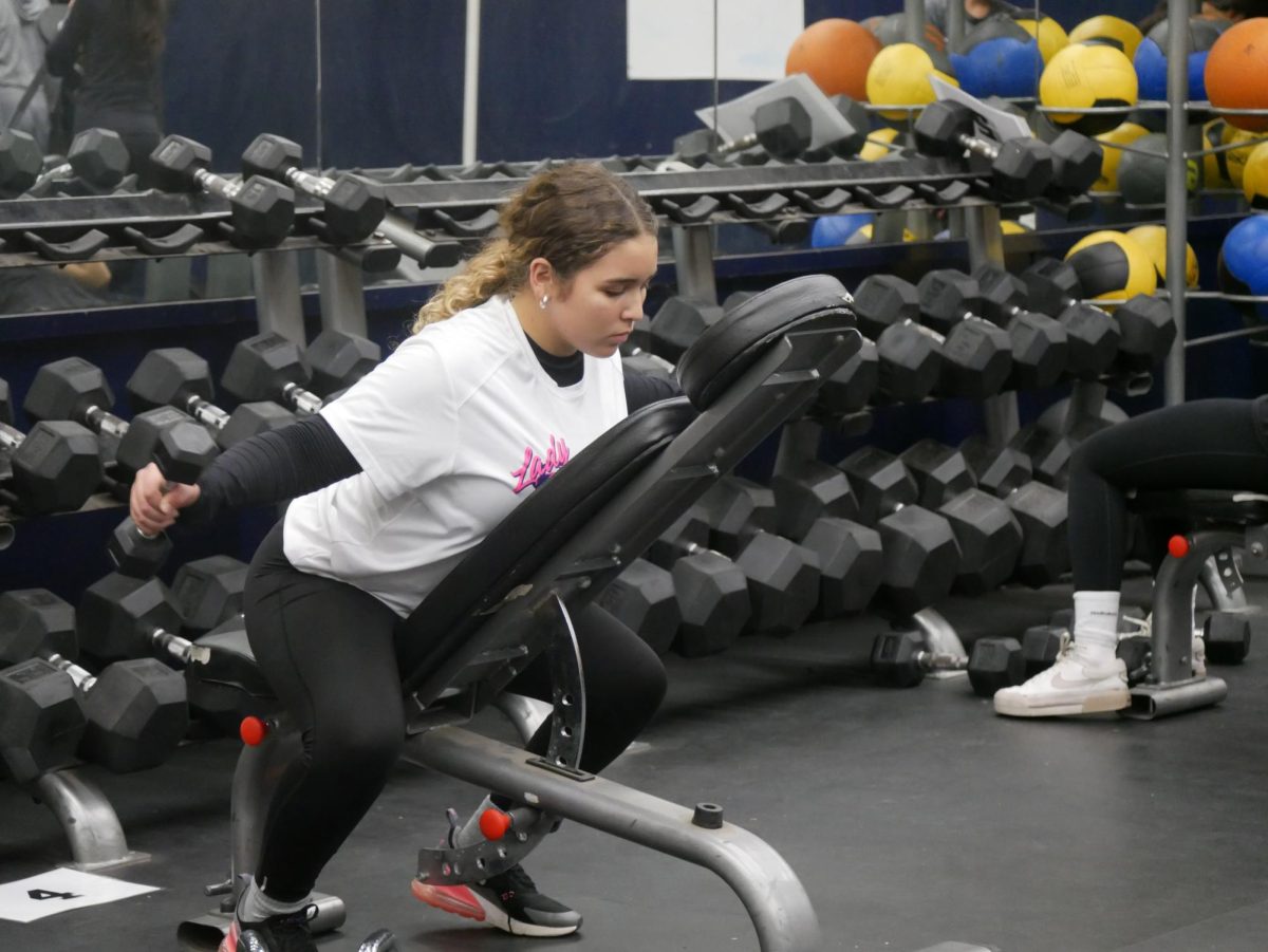 On Dec. 9, BVH softball uses the weight room to prepare for their pre-season. Sophomore Gia Feliz prepares to working her upper body to play in the infield.