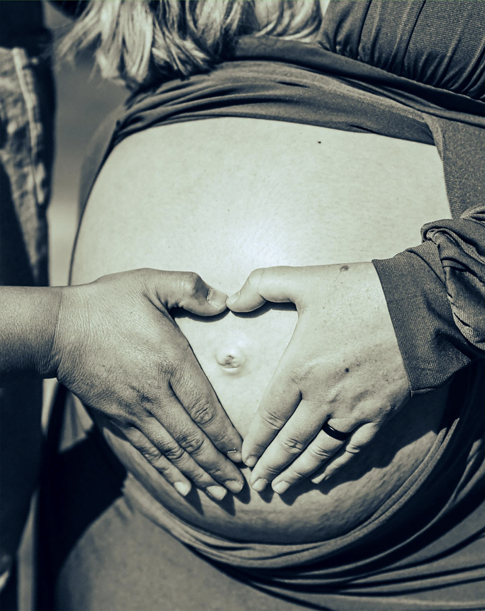 Submission photo of BVH student Marc Espina's work, featuring a two hands hands making a heart on a pregnant mother's belly. 