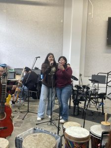 Seniors Tatiana Miranda and Evida Mejia sing mariachi songs together at Homeboy Industries 