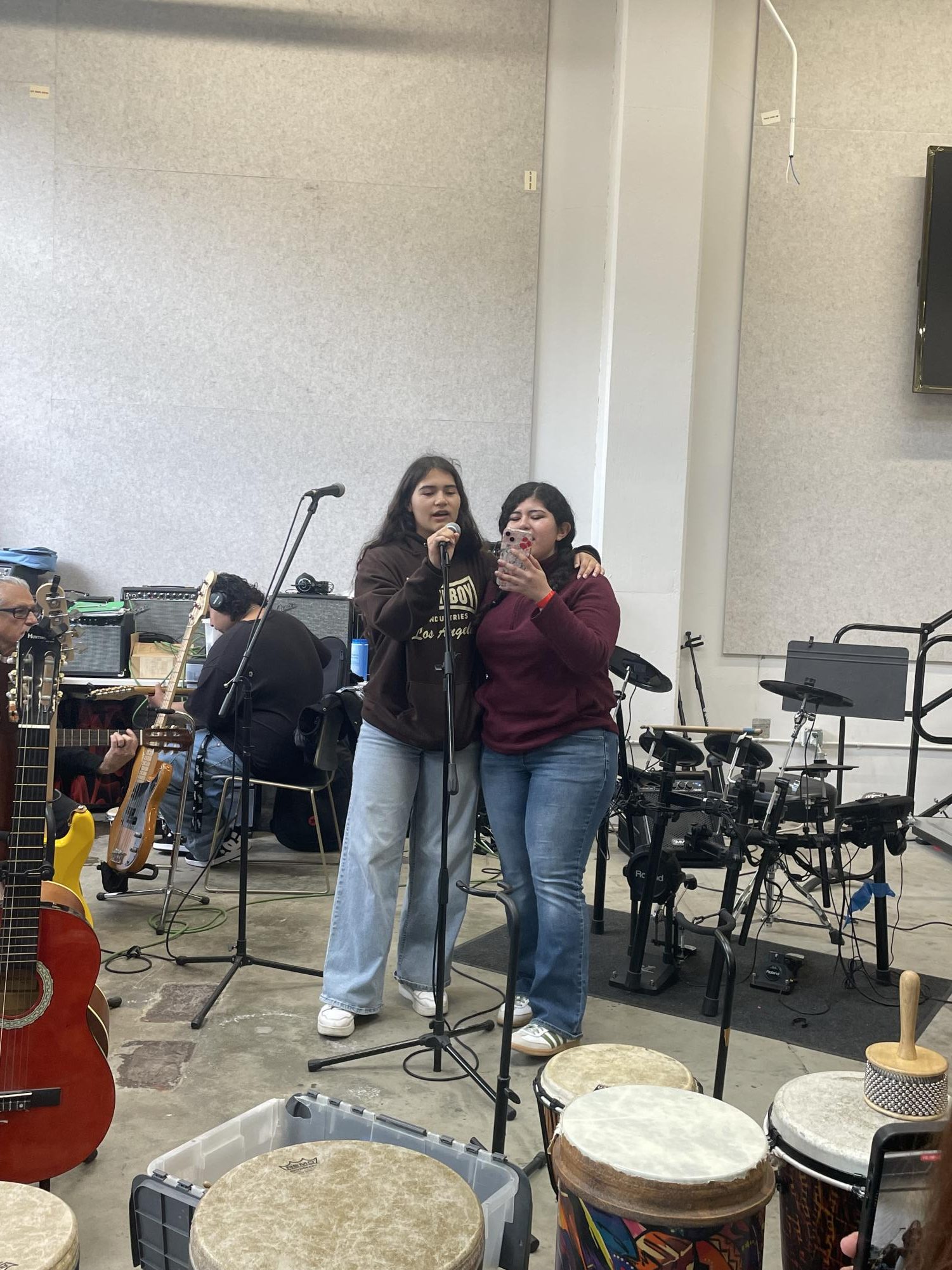 Seniors Tatiana Miranda and Evida Mejia sing mariachi songs together at Homeboy Industries 