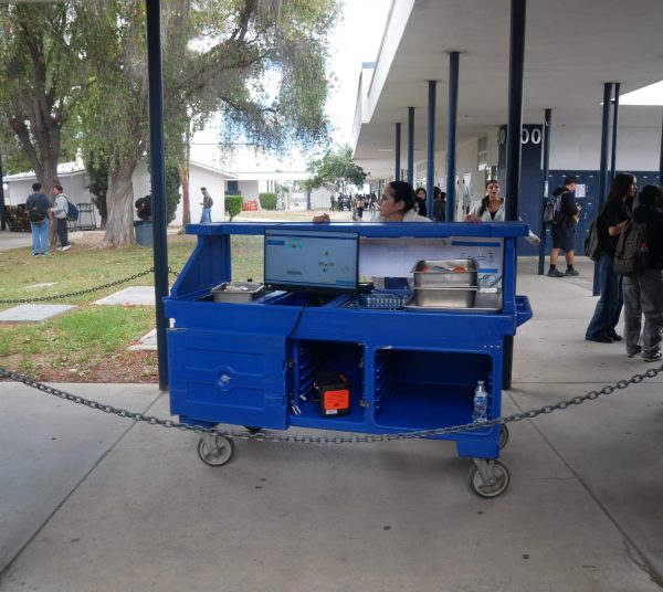 The lunch staff drag away the food cart, indicating the period to receive school lunch has ended.