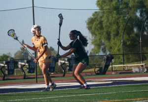 On Apr. 8, the Lady Barons beat the Hilltop Lancers 12-7 in a home game match. In the second quarter, Senior Laurette Gonzalez (9 - shown left) has possession of the ball as she looks for another player to pass it to.