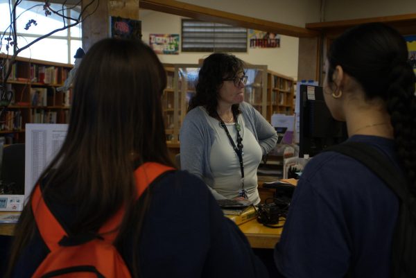 BVH librarian Adrienne Marriott assists seniors Susana Gonzalez and Isabel Arguelles at the library help desk.
